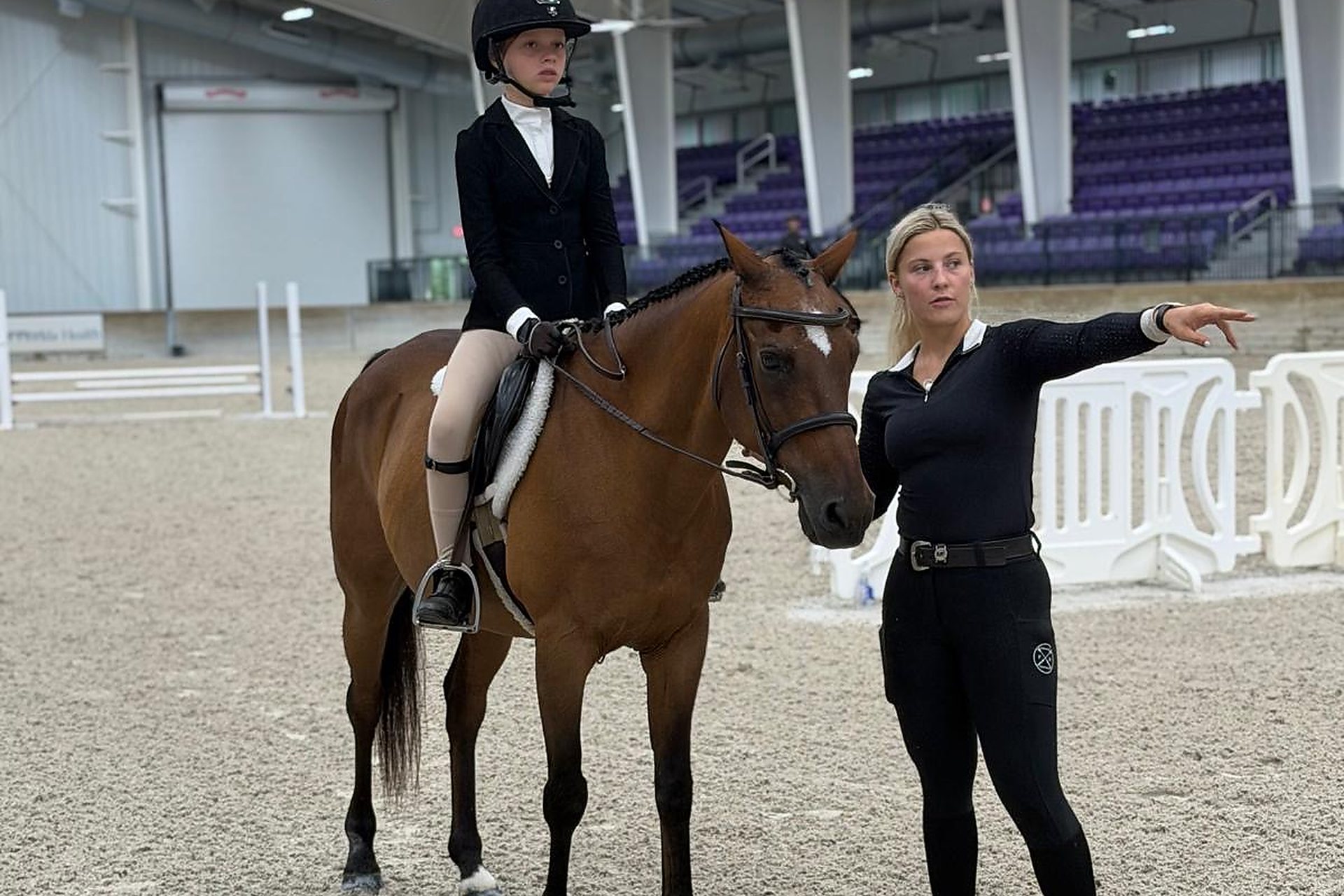 Leigh Kostmayer coaching a junior rider in the arena at World Equestrian Center Ocala
